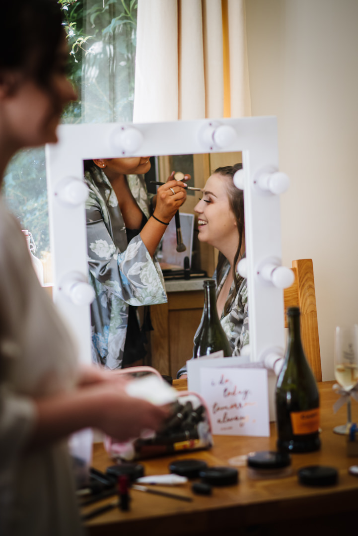 reflection in the mirror of bridal preparation before wedding at essendon country club