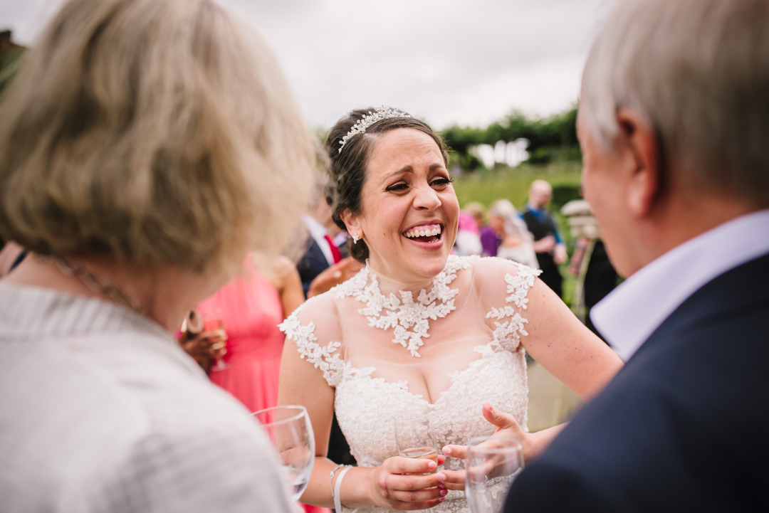 brides laughs with elders guests