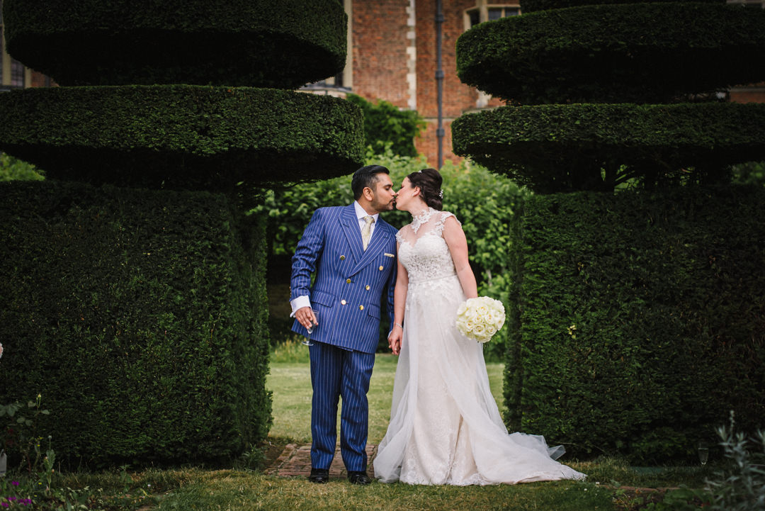portrait of bride and groom amongst the foliage at hatfield house