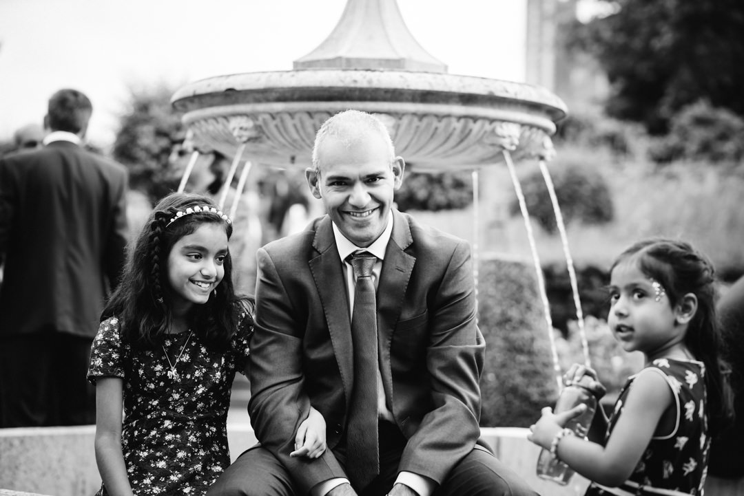 wedding guest and his daughters enjoy the fountain