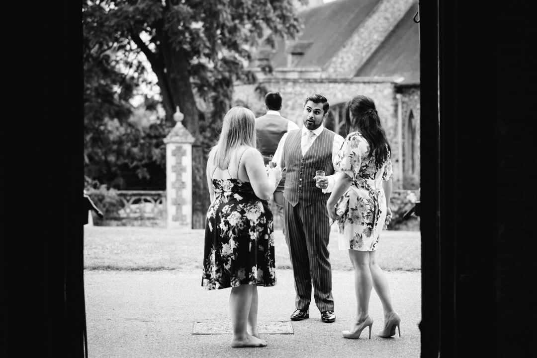 the groom chats to female friends outside hatfield house