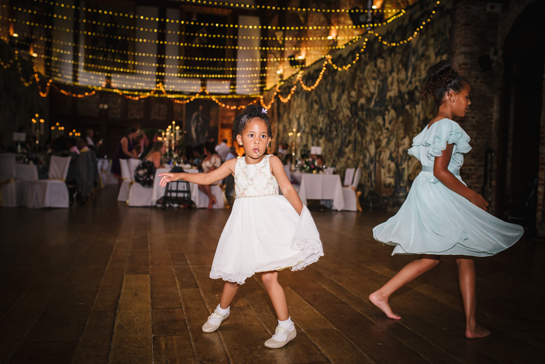 young girls twirl round on the dance floor at hatfield house wedding