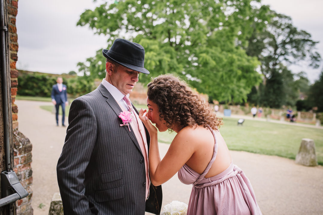 bridesmaid checks her make up in her dads tie pin