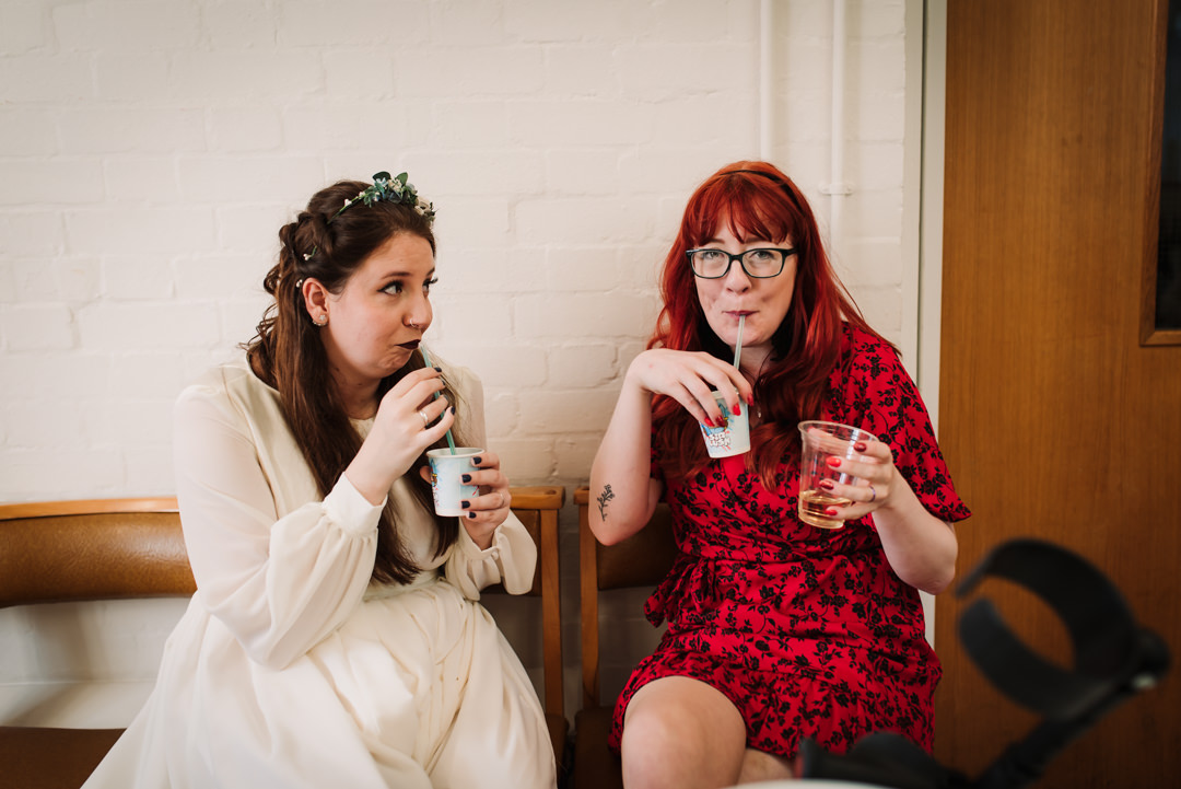 bride and her sister in law enjoy a drink at welwyn garden city wedding