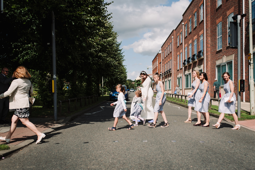 bridal party cross at the pedestrian crossing to attend their welwyn garden city wedding