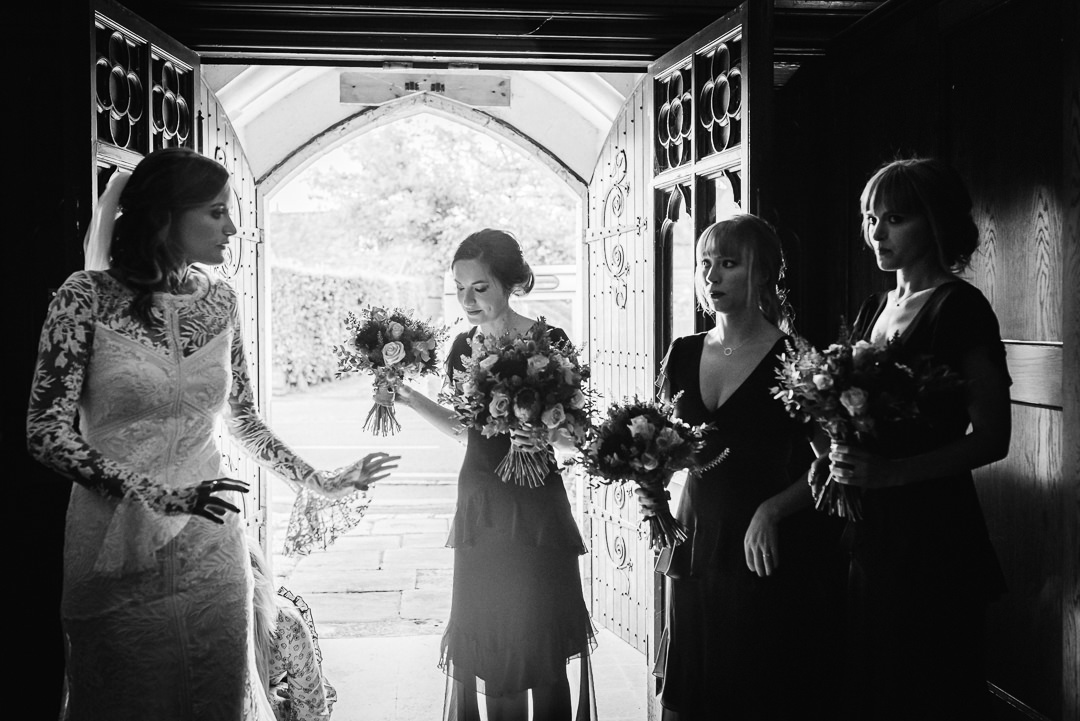 bride and bridesmaids wait nervously to be called through to the church ceremony