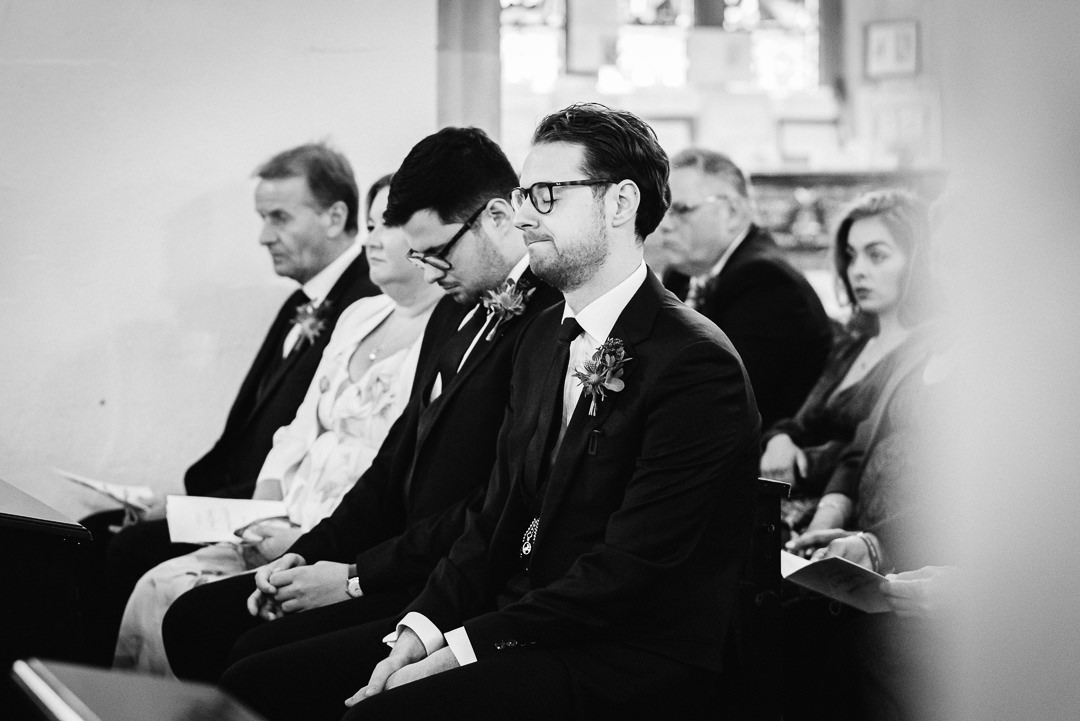 very nervous groom waits for his bride to arrive