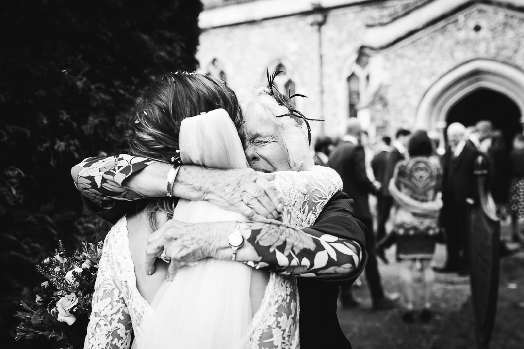 brides grandmother gives her the biggest hug after the wedding ceremony