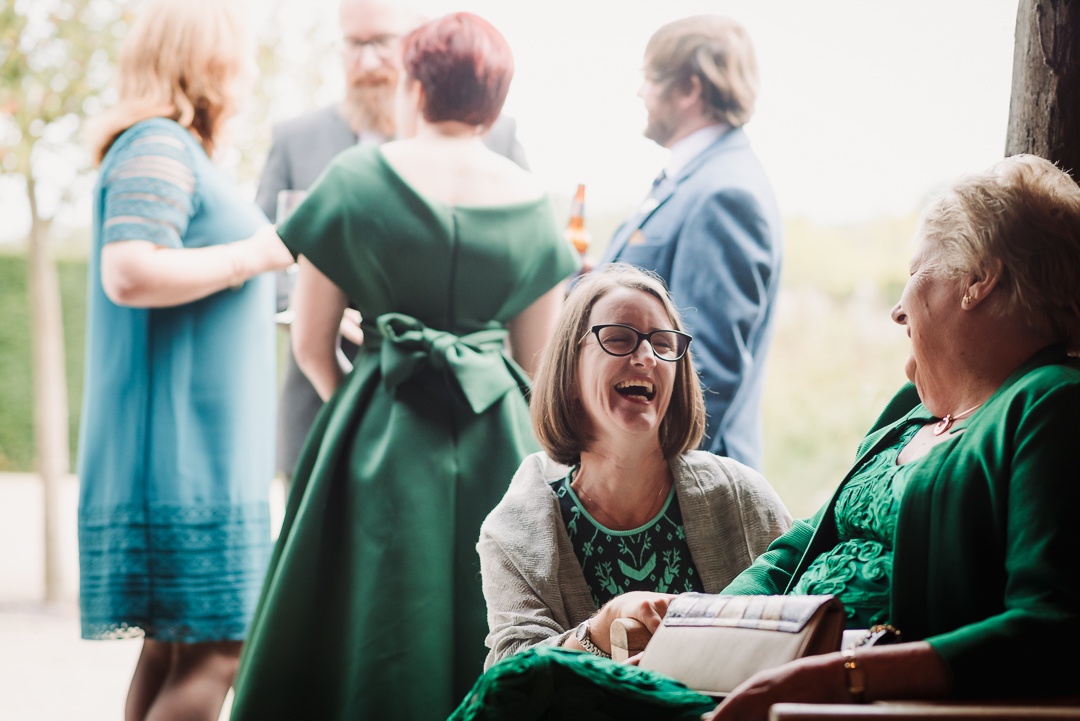 guests laugh together at micklefield hall reception