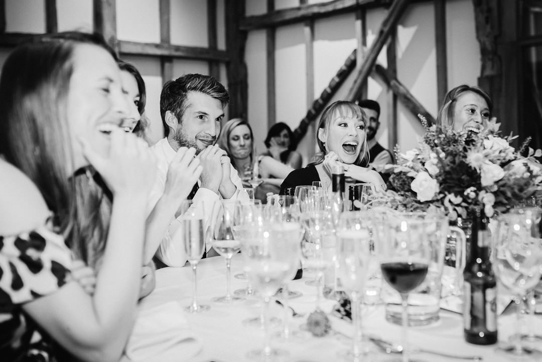 wedding guests laugh at the speeches 