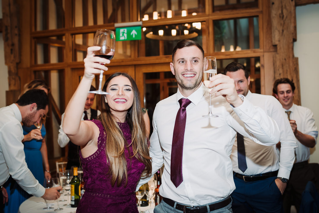 guests raise a toast to bride and groom