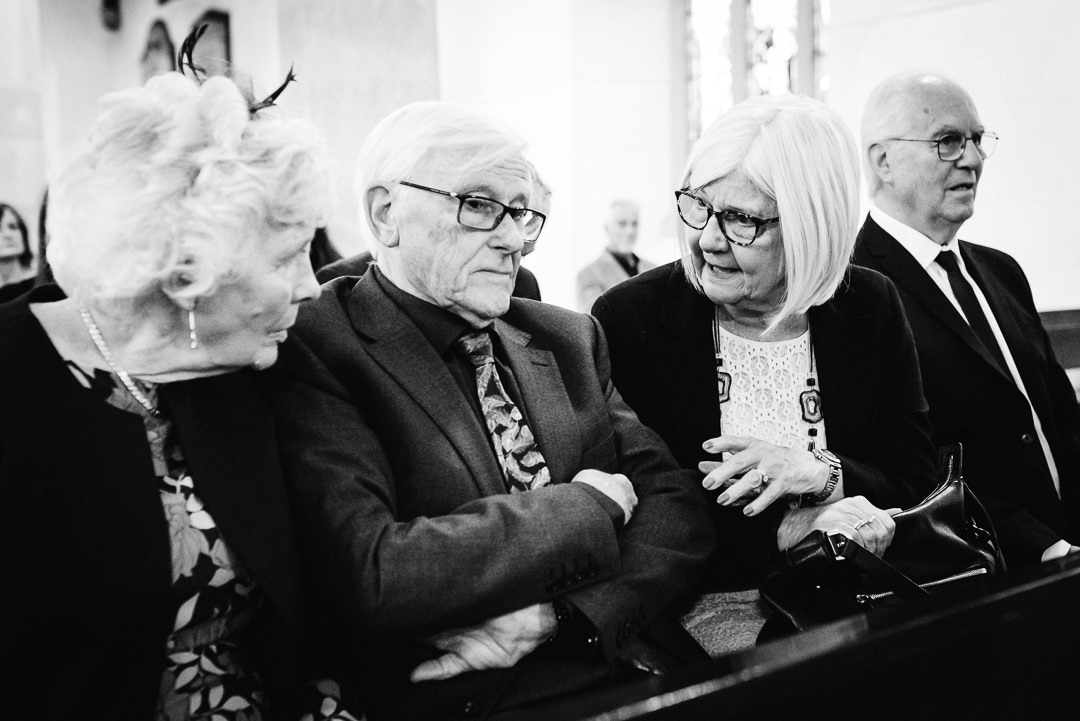 grandparents of the bride chat whilst waiting in the church