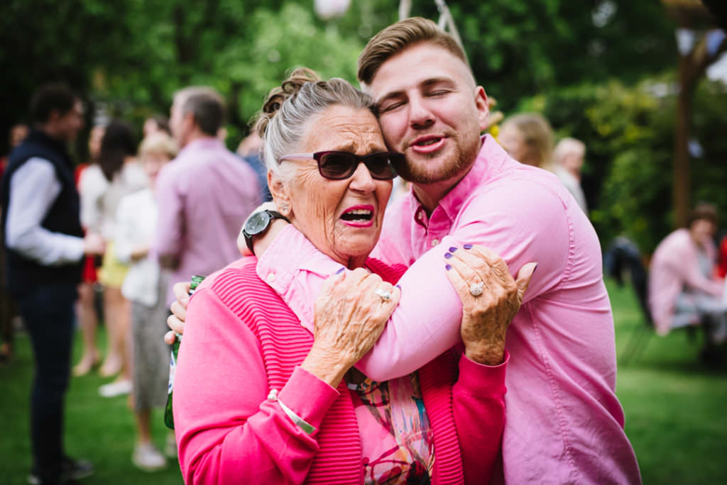 grandmother warmly hugs her grandson at hertfordshire party