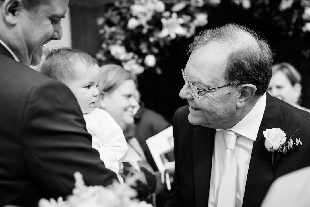harpenden wedding photographer captures a quick look between baby and grandfather