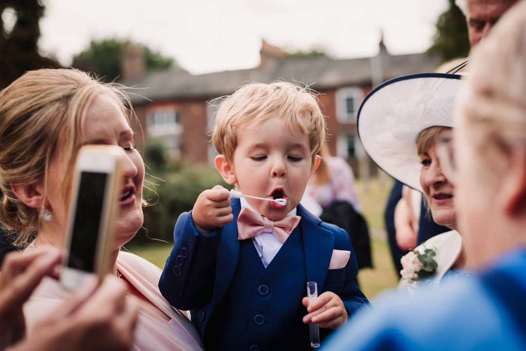 small guest enjoys blowing bubbles at the church