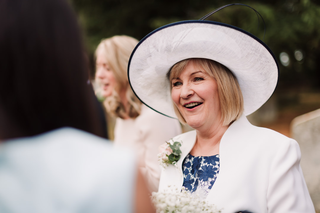 mother of the bride relaxes after the harpenden wedding ceremony
