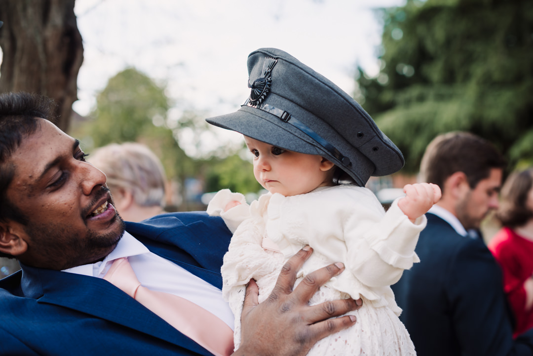 tiny wedding guest borrows the wedding chauffeurs hat