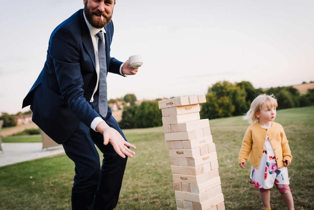 adults play outdoor wedding games at harpenden golf club wedding