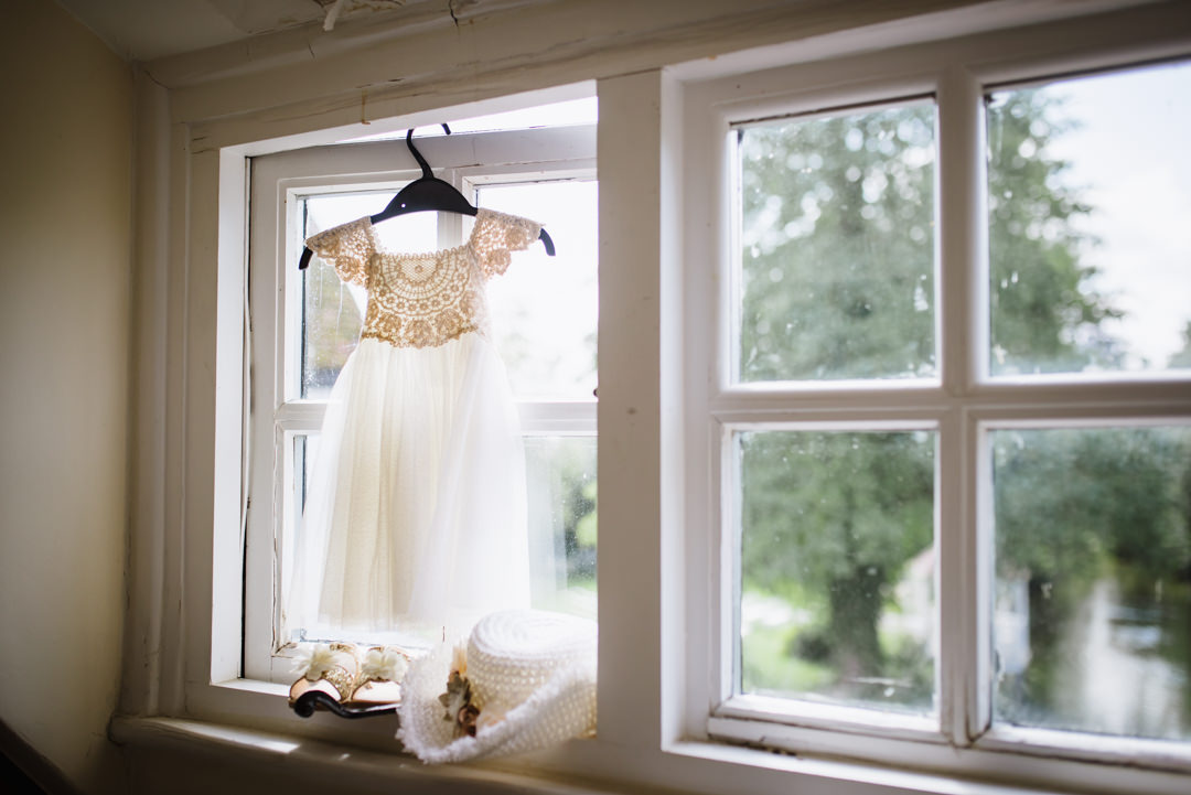 pretty bridesmaid dress hanging in the window