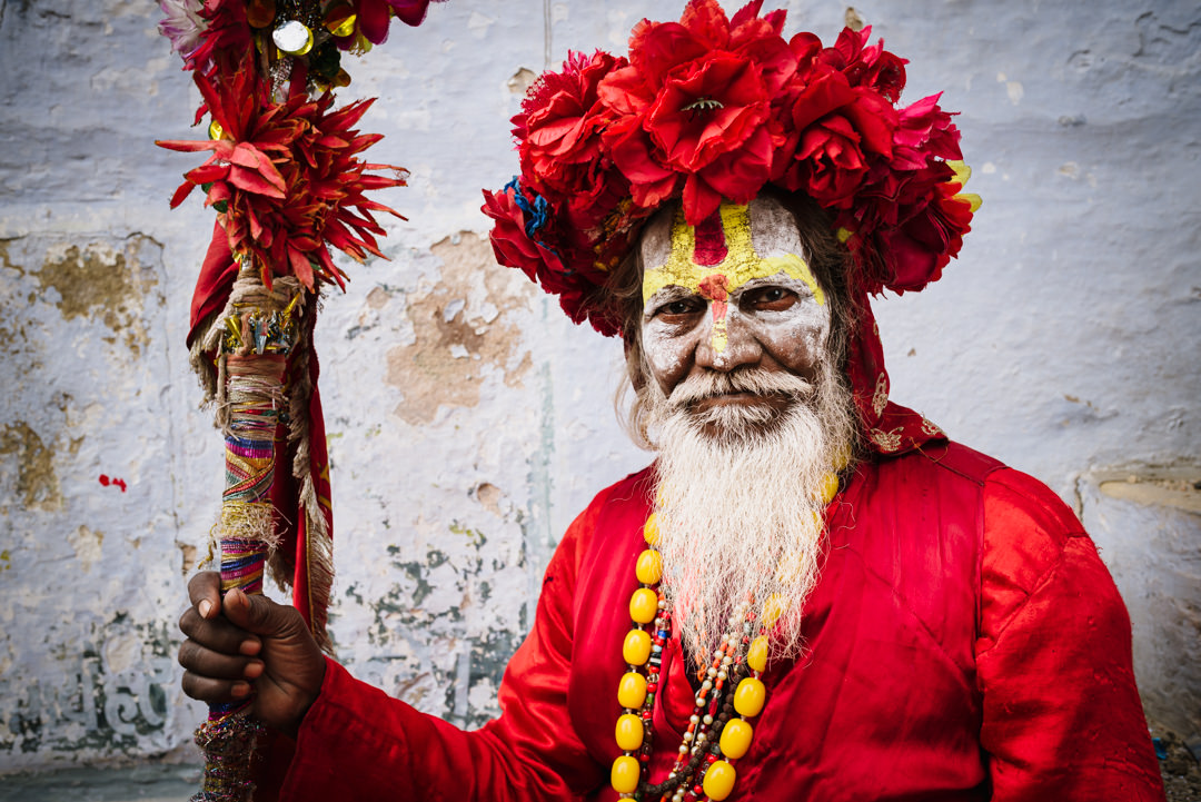 colourful holy man sits for varanasi street photographers portrait session