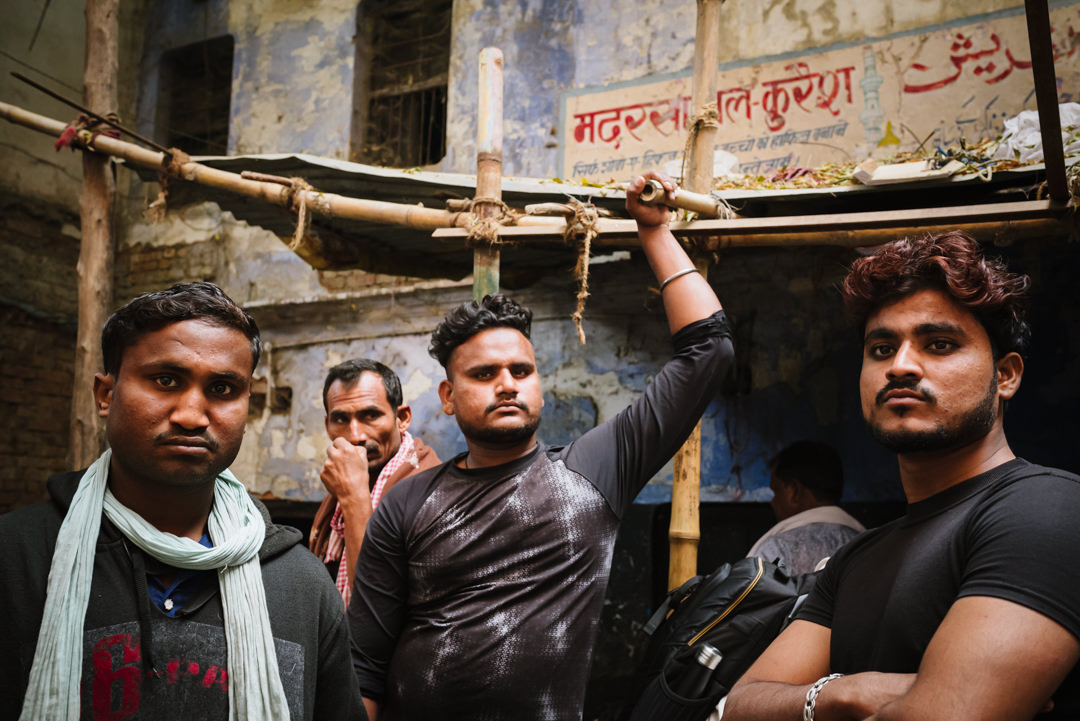 men stood waiting for a varanasi goat market sale