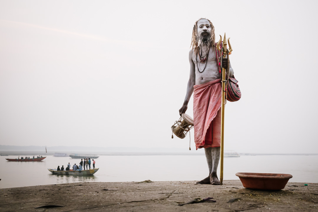 holy man poses in the morning mist for varanasi street photographer