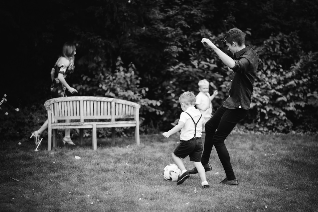 child wedding guests enjoy football in the garden of sheene mill