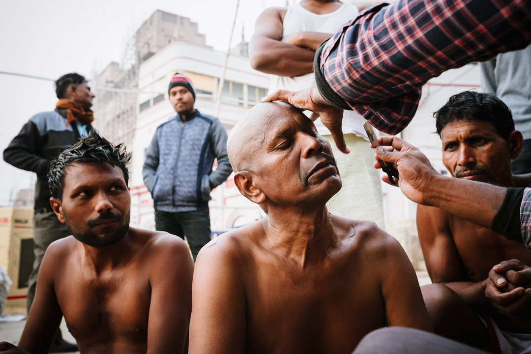 varanasi street barbers shaving customers heads