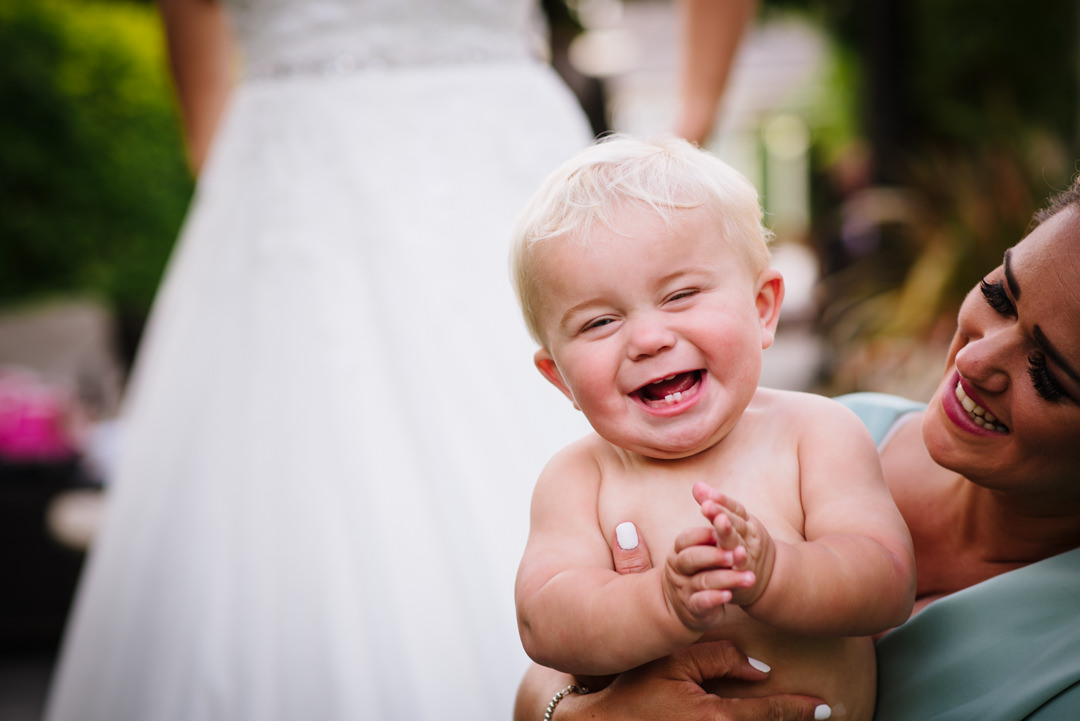 podgy baby wedding guest laughs at sheene mill wedding photographer