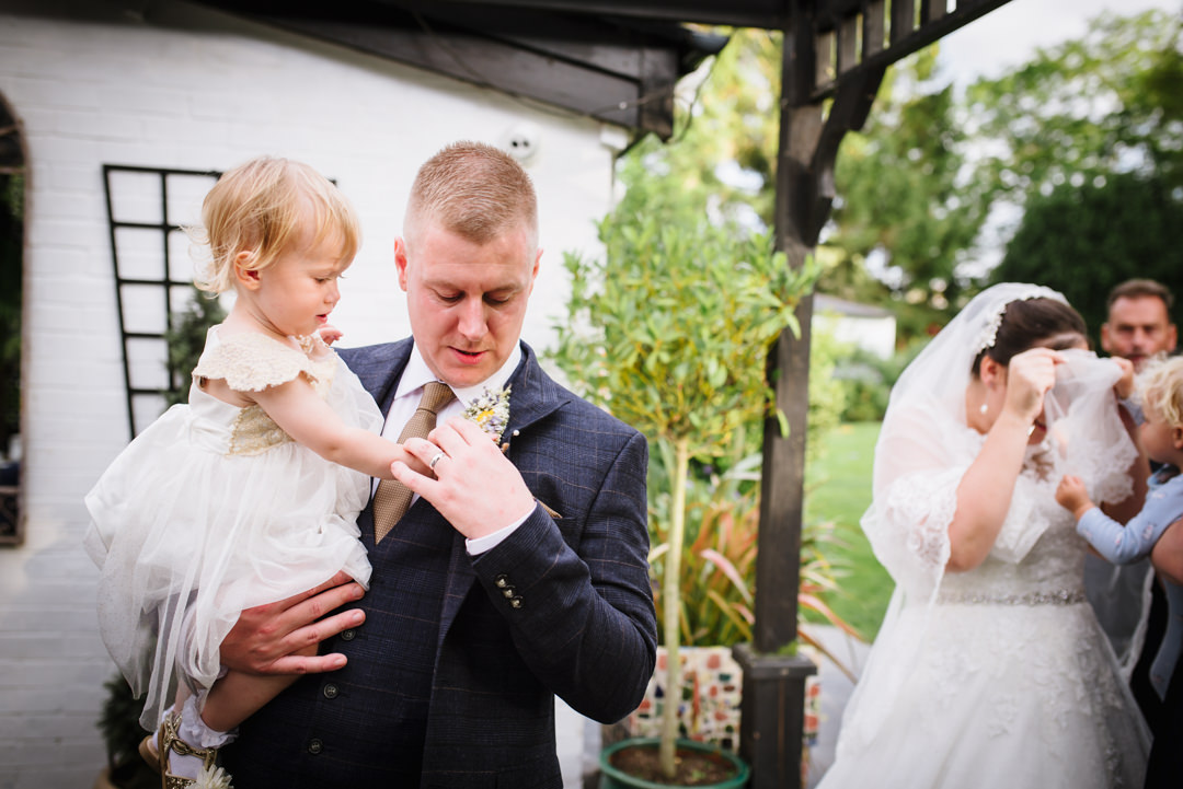 sheene mill wedding photographer captures a tender moment between groom and his daughter