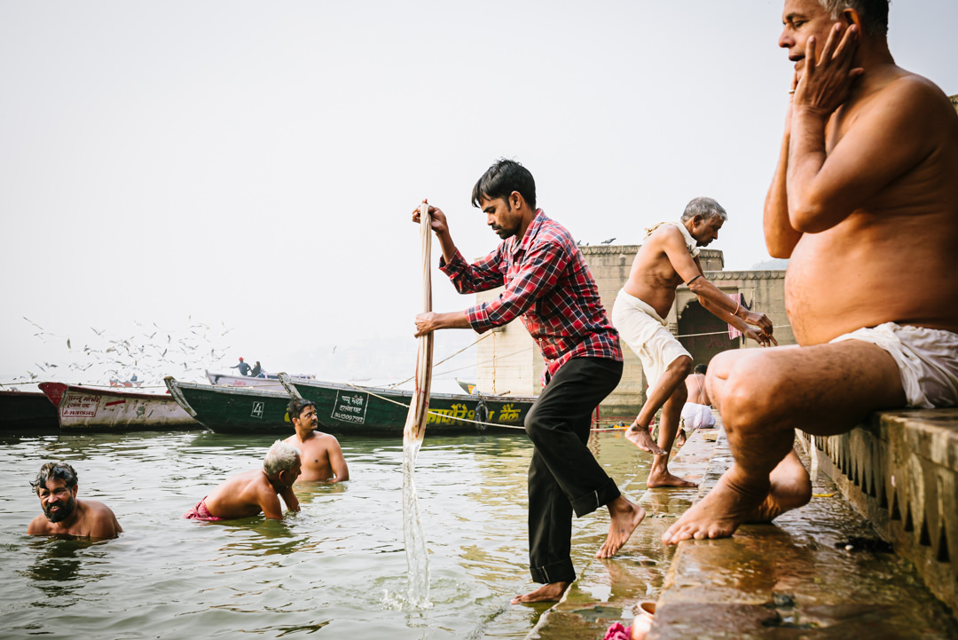 men wash in the varanasi ghats early morning