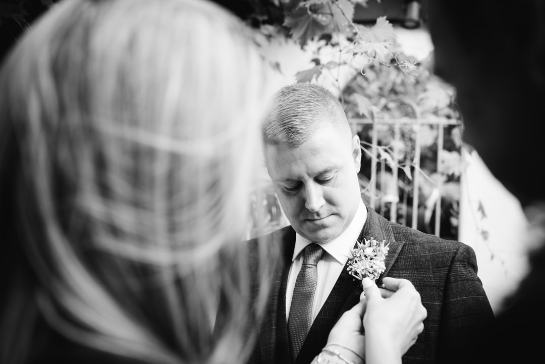  groom putting on his button hole