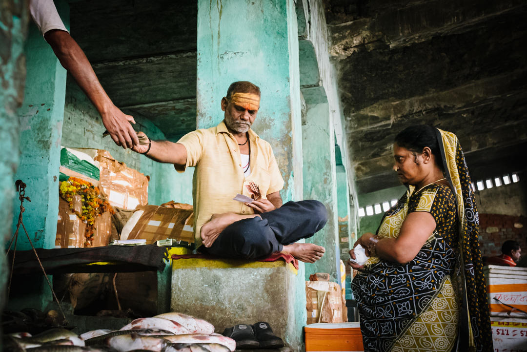 varanasi street photography captures fish market exchange