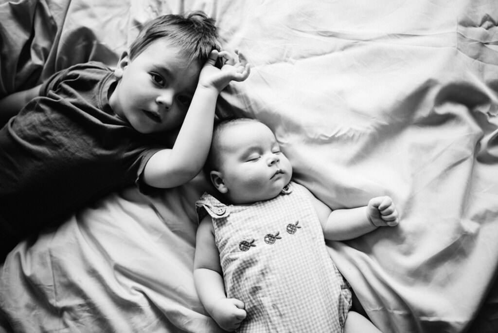 brothers lie on the bed for their family photography
