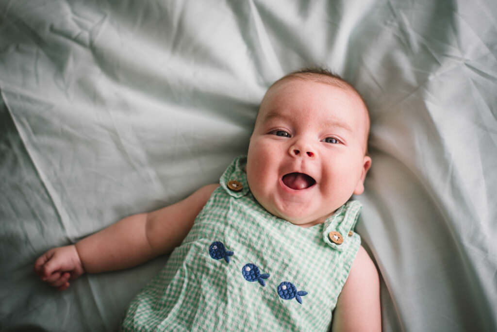 smiling baby looks straight at camera for his baby photography