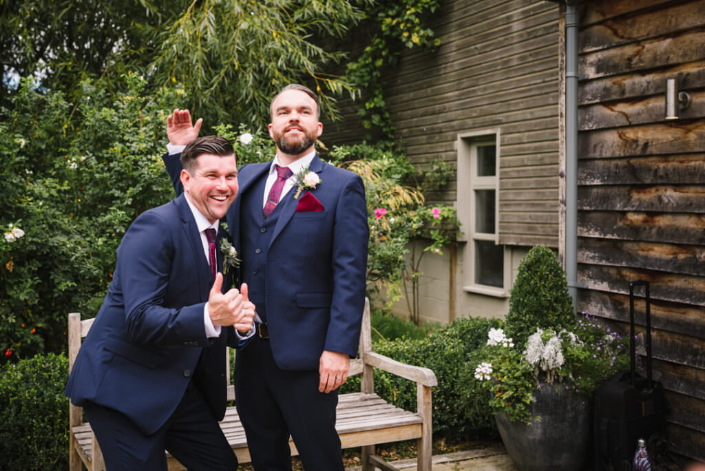 groom and his brother joke for their hertfordshire wedding photos