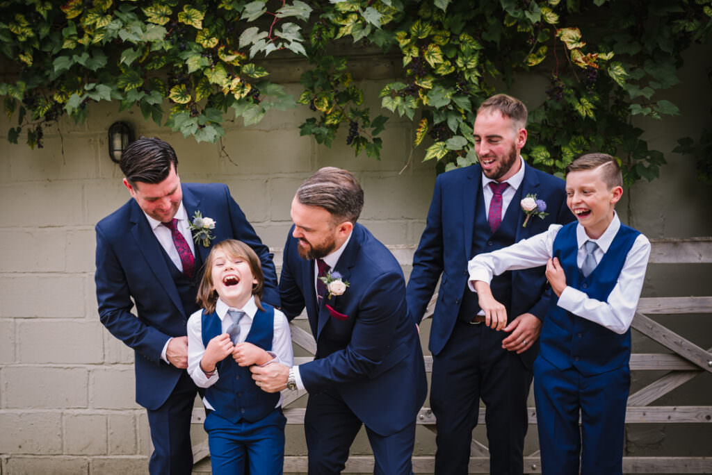 groomsmen mess around whilst houchins wedding photographer captures the fun