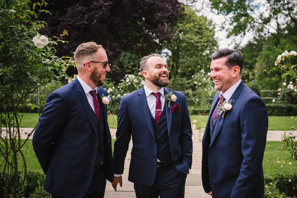 groom and best men joke at houchins farm wedding 