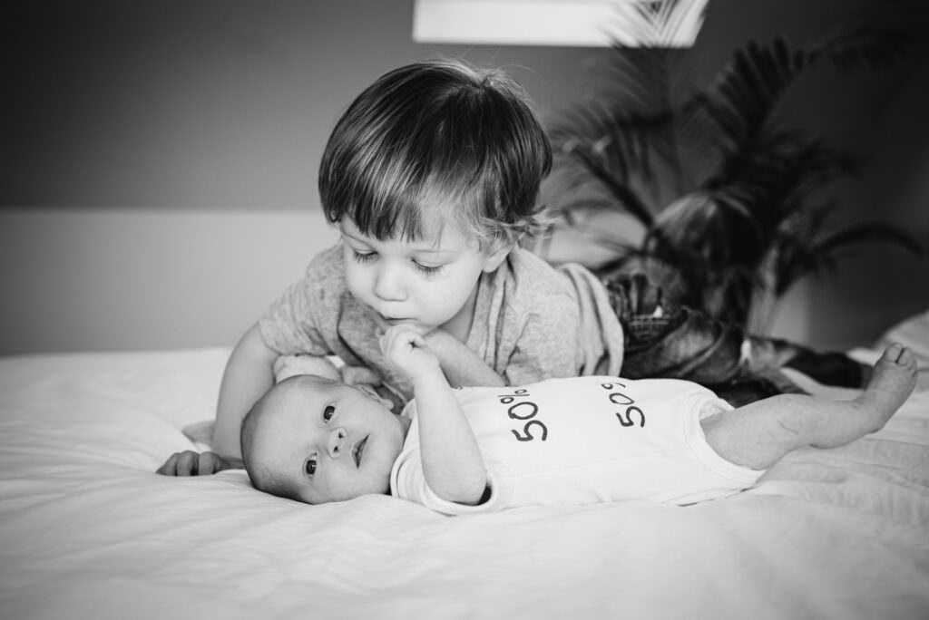 brothers kiss for their hertfordshire newborn photographer