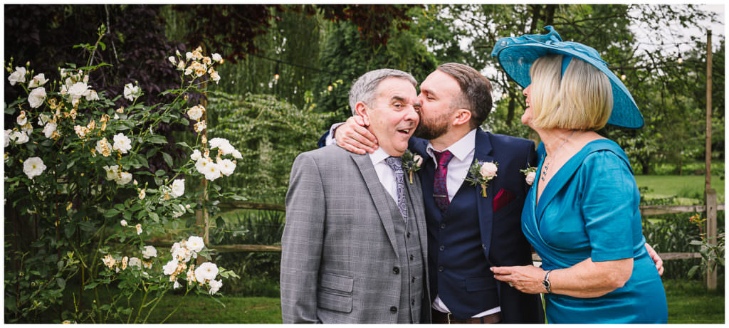 groom kisses his parents at his hertfordshire wedding
