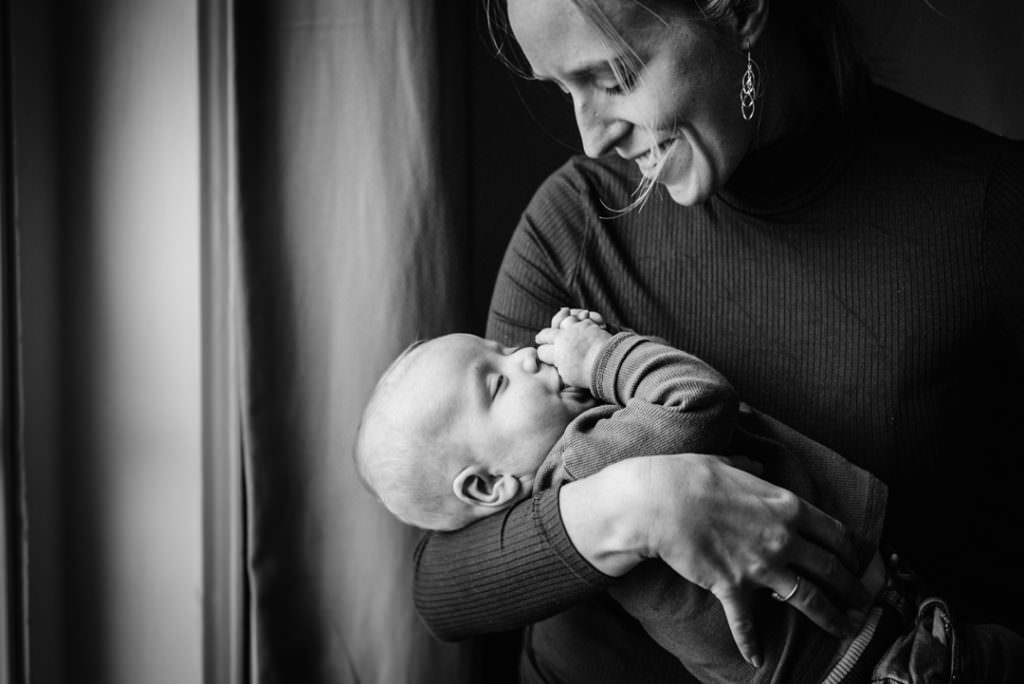 hertfordshire newborn photography with mother and baby in soft window light