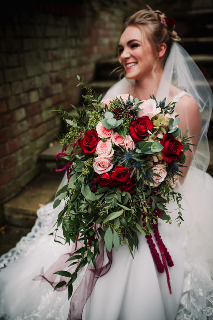 laughing bride holds her bouquet