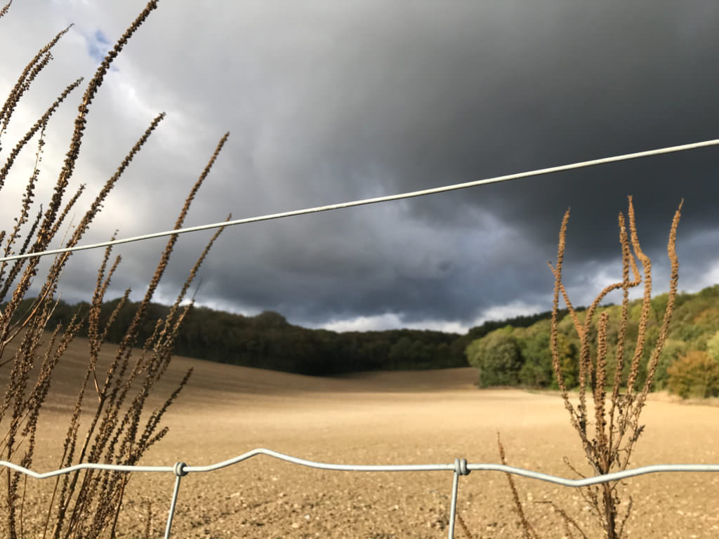 walk across hertfordshire with dark clouds in the sky