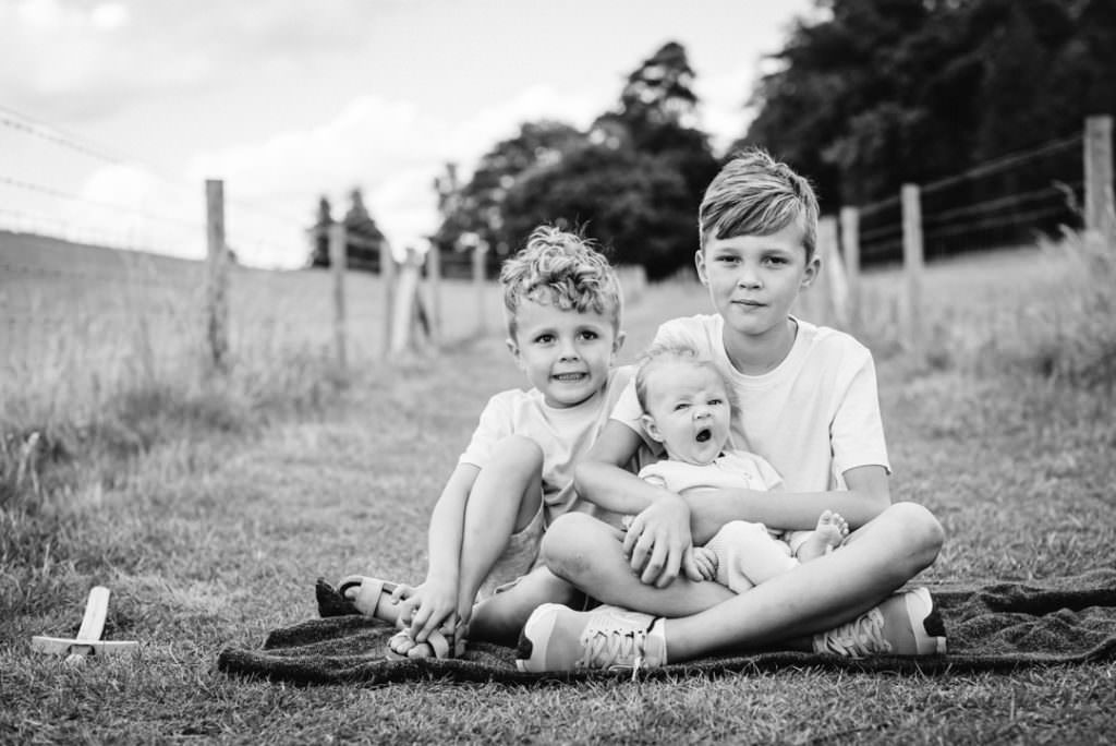 family photography including three brothers in a hertfordshire field