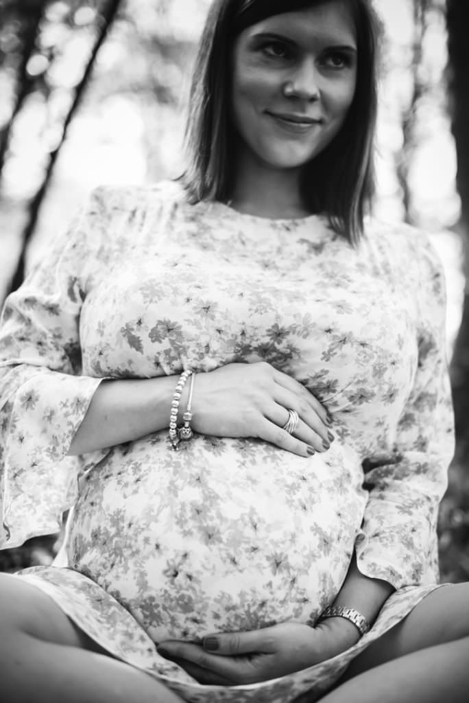 Pregnant mum sits for a maternity photoshoot in outdoors location in Hertfordshire