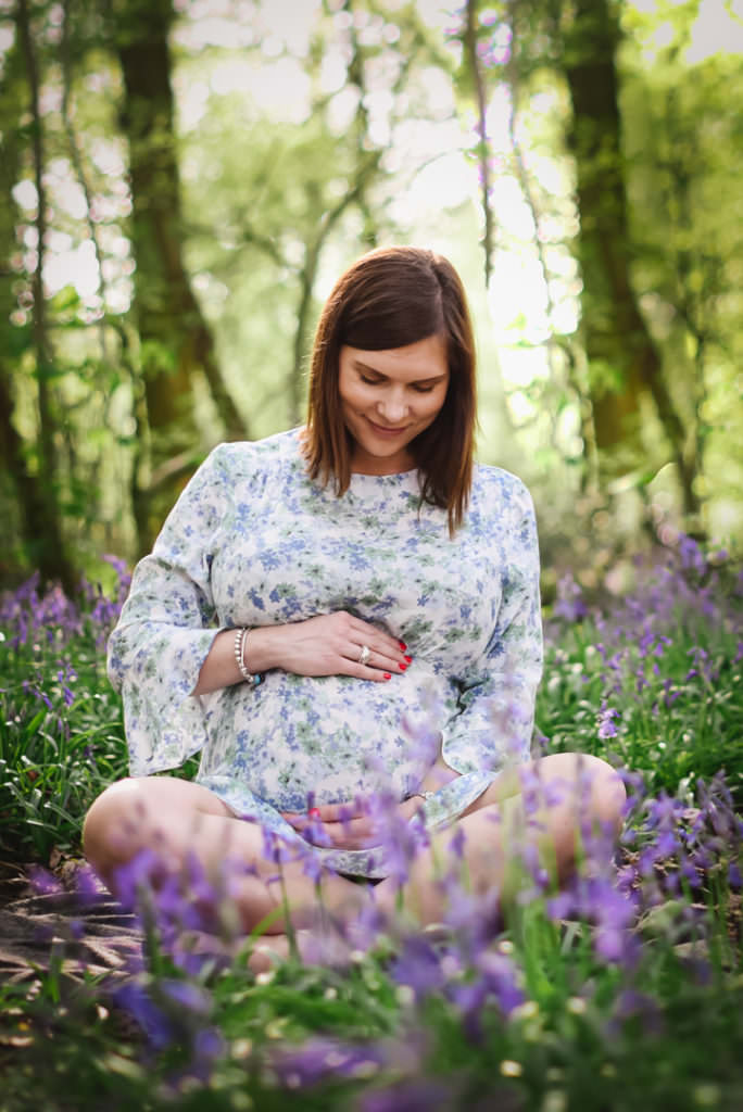 Hertfordshire maternity photographer captures new mum holding her bump tenderly