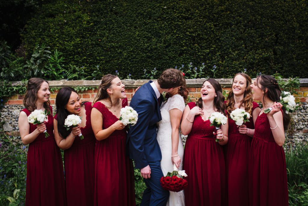 Laughing bridal party joke as london wedding photographer documents the moment