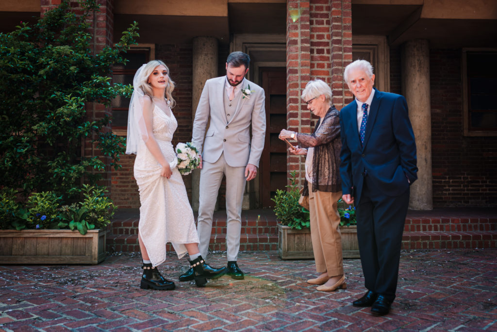 brides grandparents look at her shoes during her uxbridge wedding