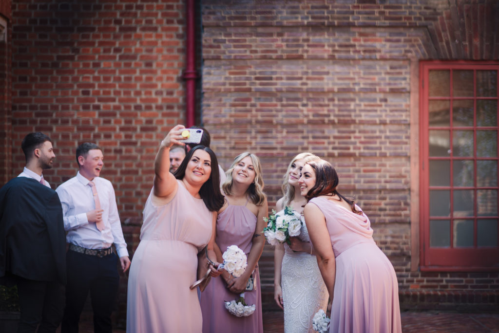 bridesmaids take a few selfies after uxbridge wedding ceremony