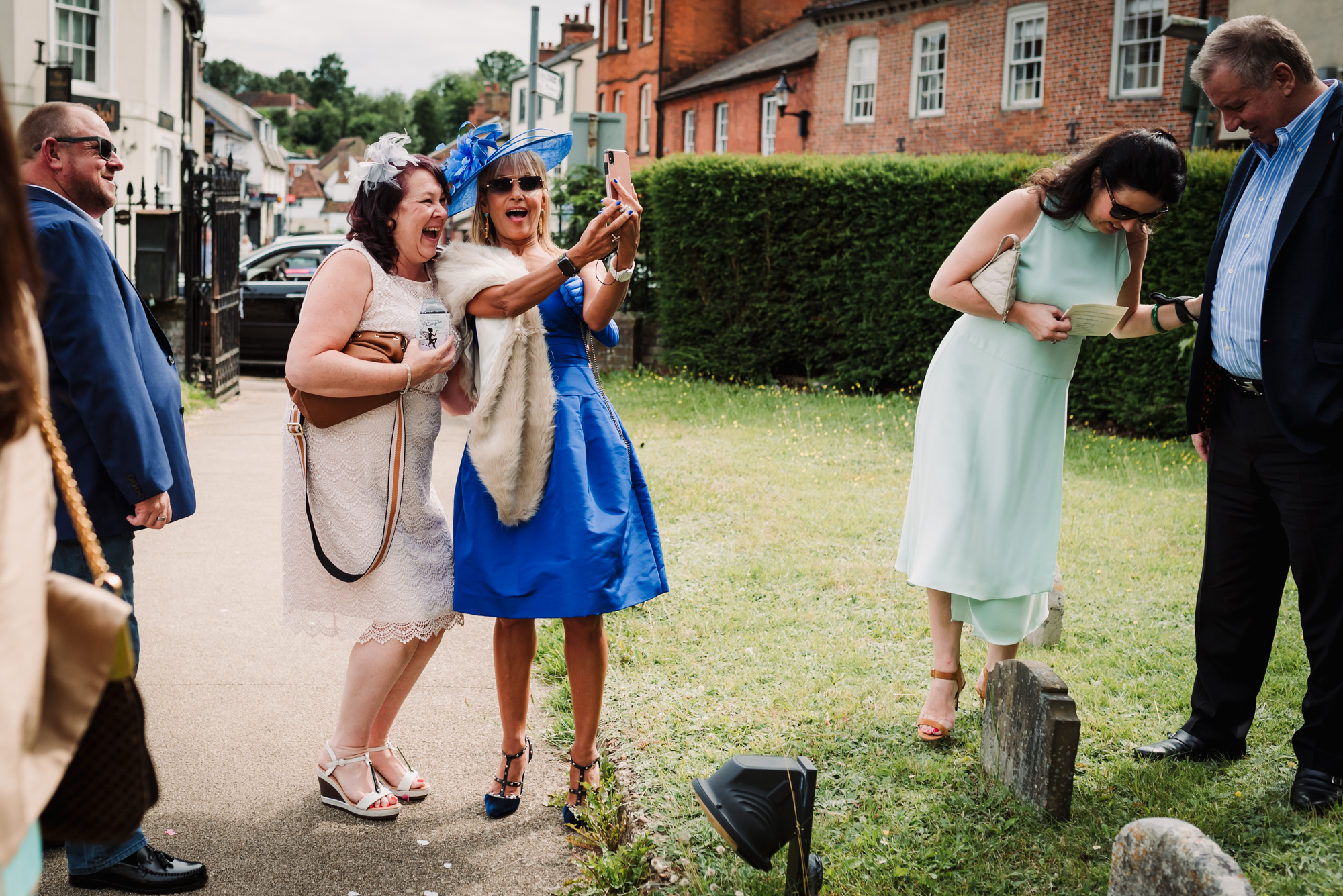 Wedding photographer captures guests taking selfies outside the pub in Hertfordshire